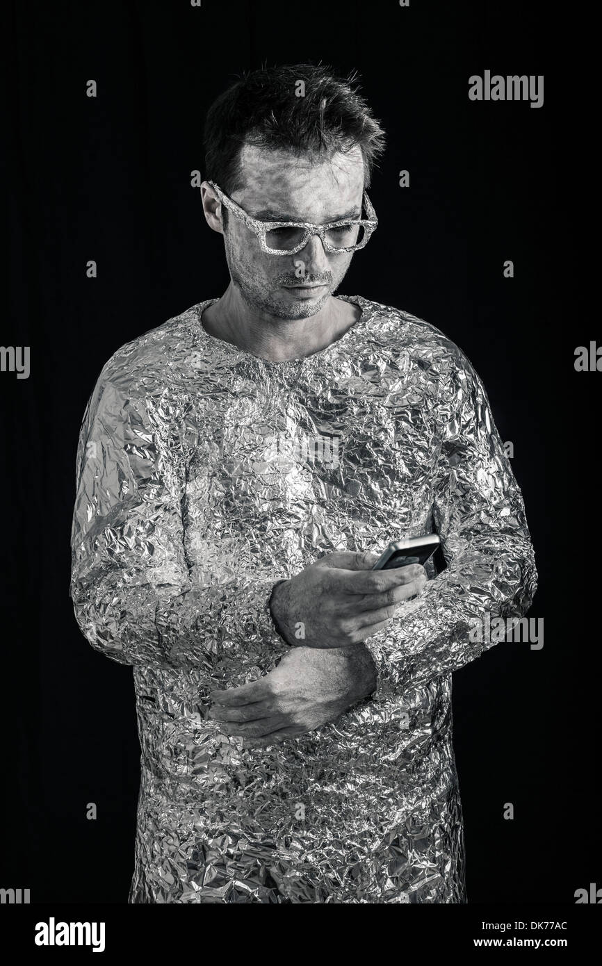 Portrait of spaceman using mobile phone. Stock Photo