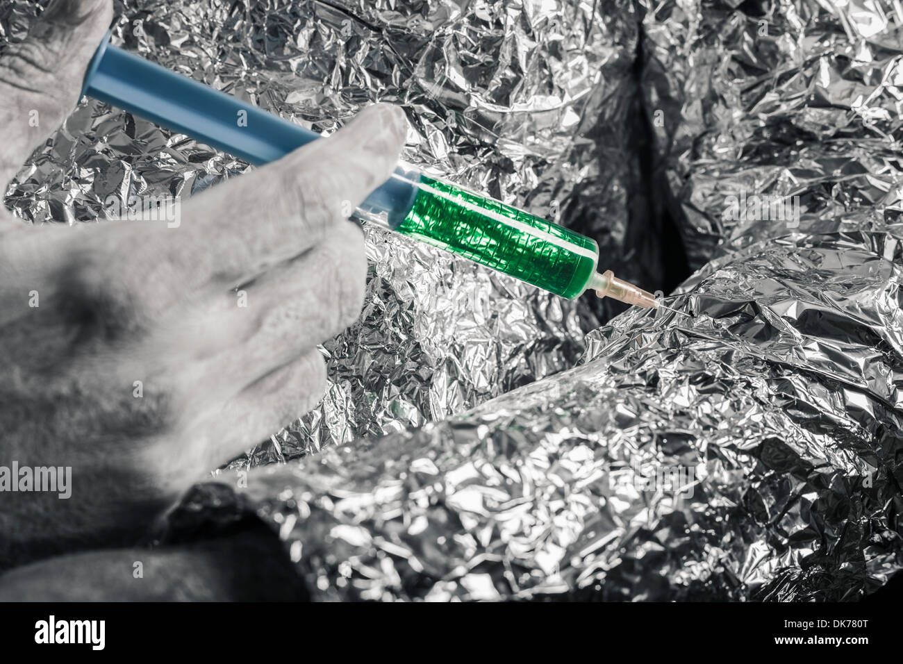 Closeup of cyborg hand applying syringe. Stock Photo