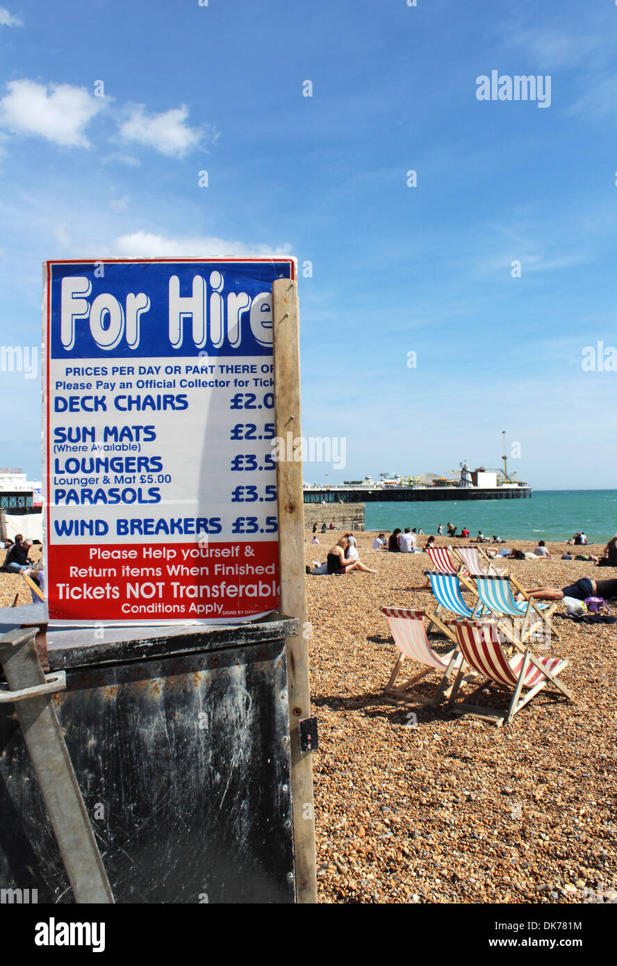 Brighton beach with deckchair for hire sign and prices, East Sussex