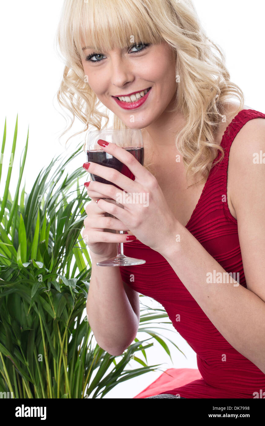 Confident Happy Casual Young Woman Alone Enjoying A Glass Of Red Wine Waiting For the Party To Start Isolated Against A White Background Clipping Path Stock Photo