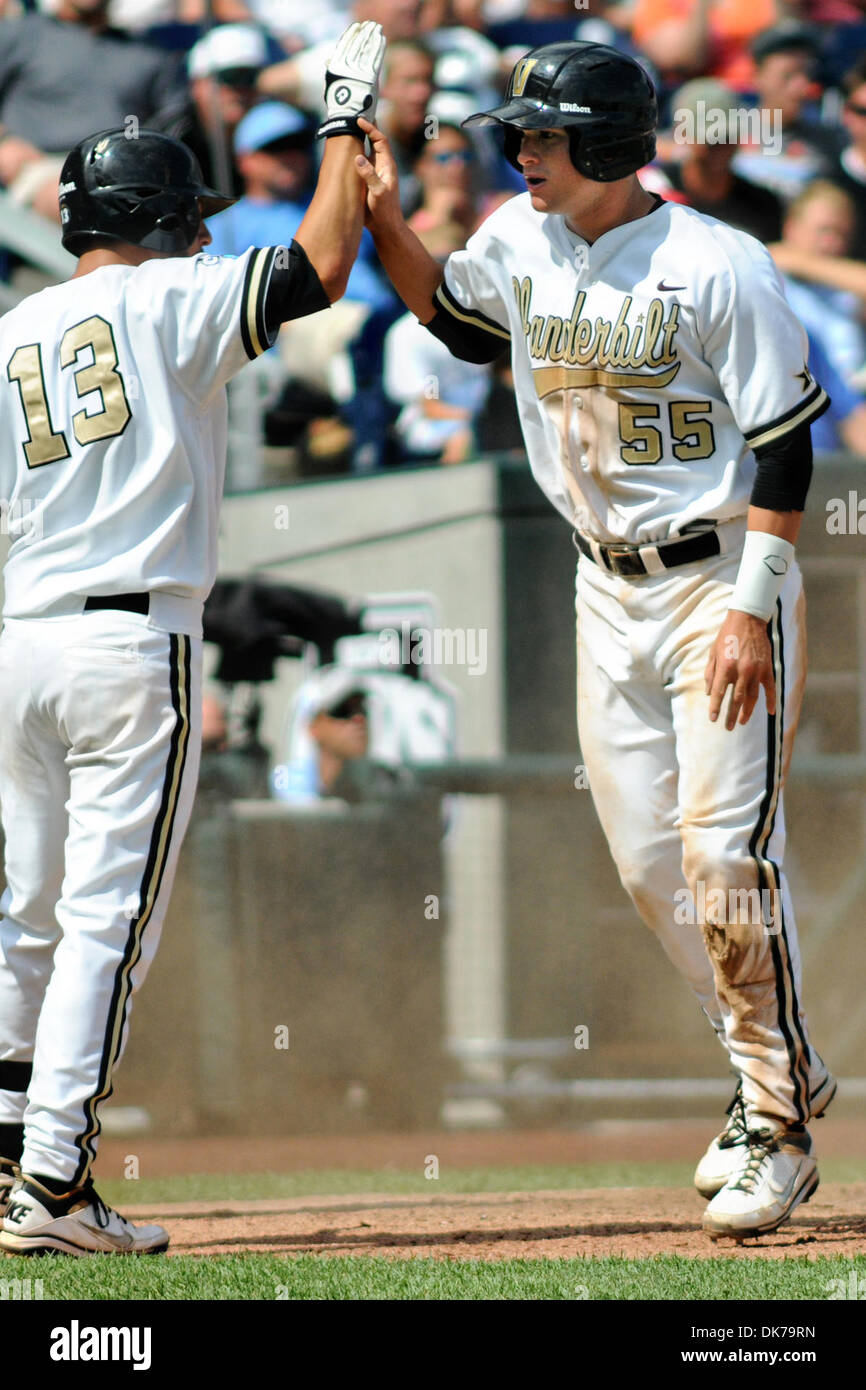 June 18, 2011 - Omaha, Nebraska, U.S - Conrad Gregor (55) receives congratulations from Anthony Gomez (13) after scoring in the sixth inning. Vanderbilt defeated North Carolina 7-3 in the first game of the College World Series at TD Ameritrade Park in Omaha, Nebraska. (Credit Image: © Steven Branscombe/Southcreek Global/ZUMApress.com) Stock Photo