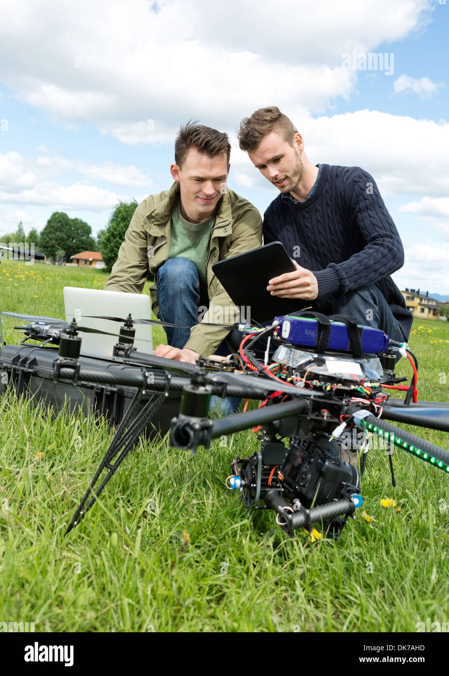 Technicians Discussing Over Digital Tablet By UAV Stock Photo
