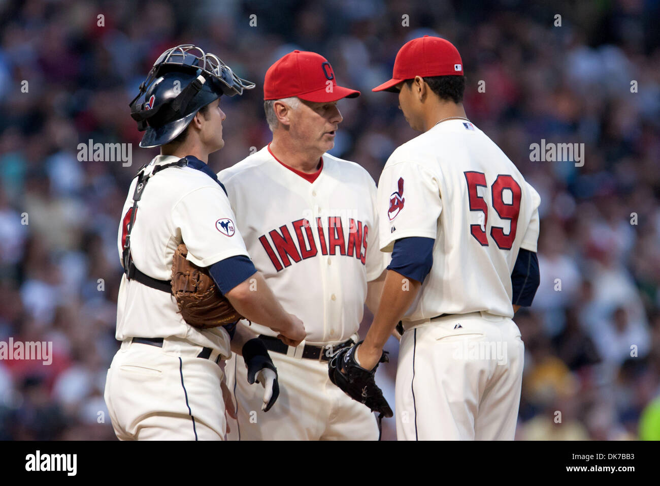 June 18, 2011 - Cleveland, Ohio, U.S - Cleveland pitching coach Tim Belcher (49) meets on the mound with catcher Lou Marson (7) and starting pitcher Carlos Carrasco (59) during the sixth inning against Pittsburgh.  The Cleveland Indians defeated the Pittsburgh Pirates 5-1 at Progressive Field in Cleveland, Ohio. (Credit Image: © Frank Jansky/Southcreek Global/ZUMAPRESS.com) Stock Photo