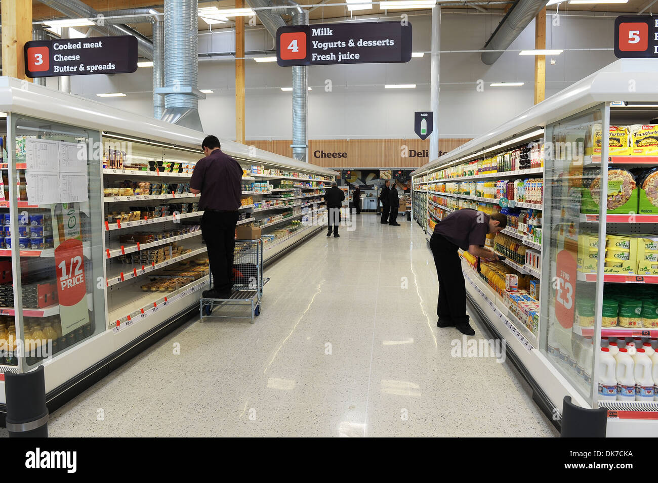Supermarket interior showing shelf stacking, Britain, UK Stock Photo