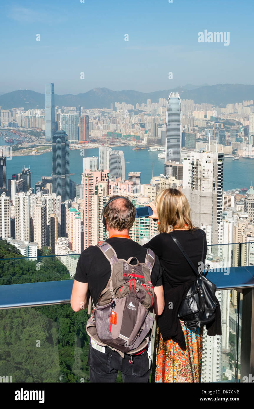 Tourists admiring view of skyline of Hong Kong from The Peak Stock Photo