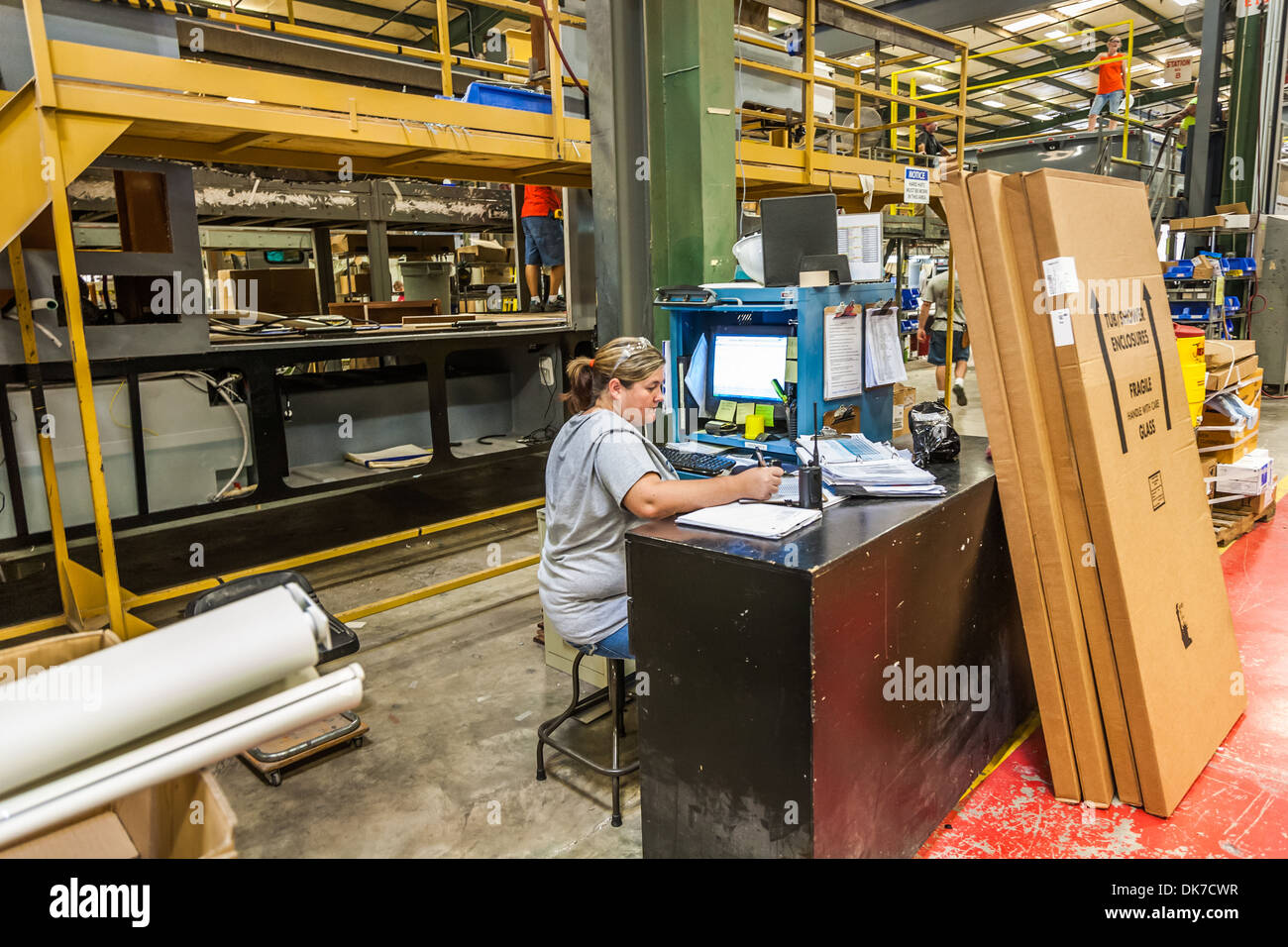 Factory employee uses SAP computer software to control production at ...