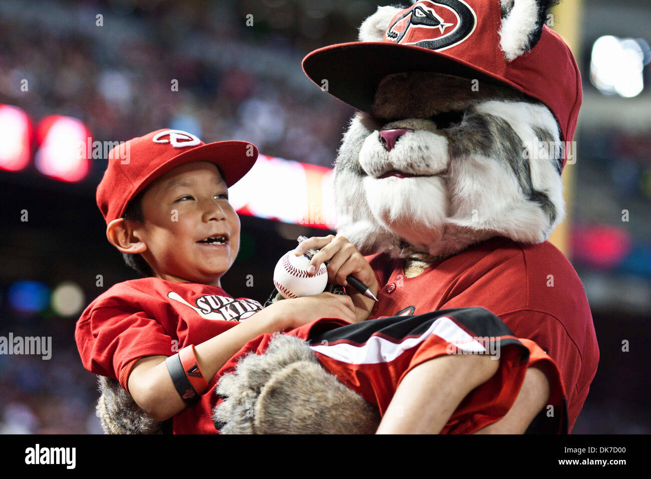 June 19, 2011 - Phoenix, Arizona, U.S - Arizona Diamondbacks' mascot  carries a young fan prior to the start of a game against the Chicago White  Sox. The White Sox defeated the