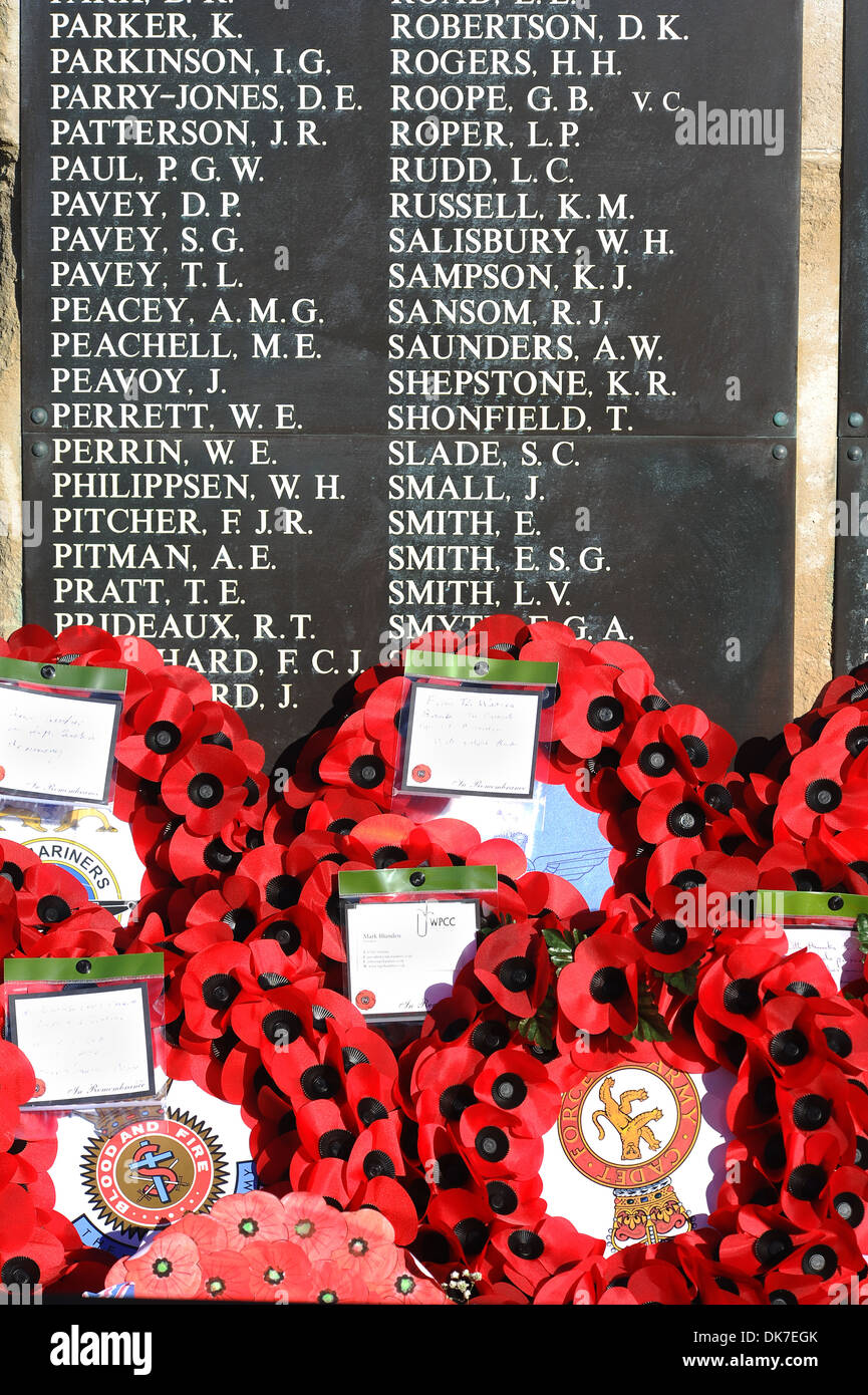 Poppy wreaths and names at a cenotaph during a Remembrance Service, UK Stock Photo