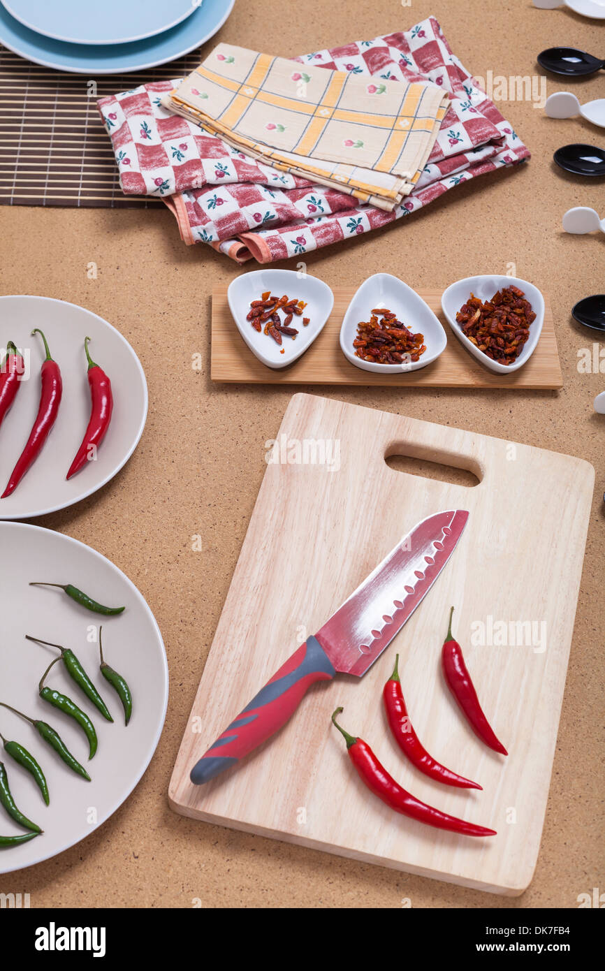 Fresh red hot chili peppers with knife on chopping board Stock Photo ...
