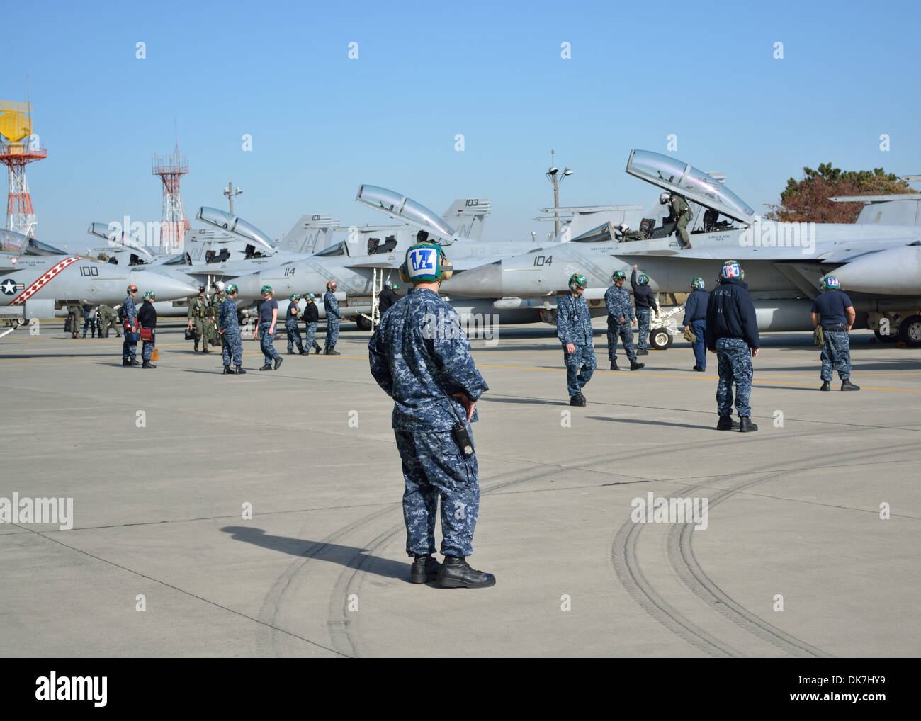 Strike Fighter Squadron (VFA) 102 crew members assist returning pilots during a homecoming celebration at Naval Air Facility At Stock Photo