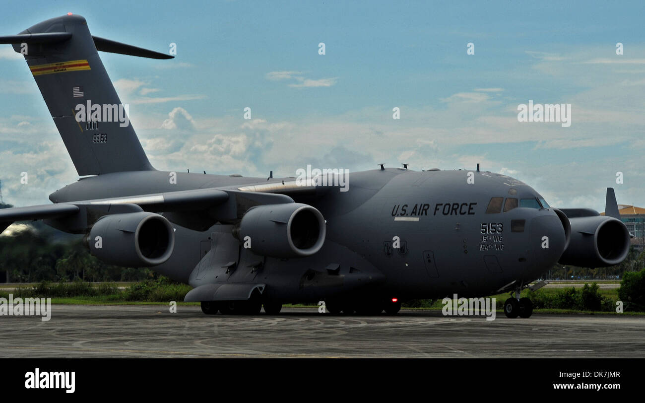 RIMBA AIR BASE, Brunei -- A C-17 Globemaster III taxis in prior to landing on the flightline at Rimba Air Base during the 4th Biennial Brunei Darussalam International Defense Exhibition, Dec. 1, 2013. JBPPH personnel will be showcasing the C-17 Globemaste Stock Photo