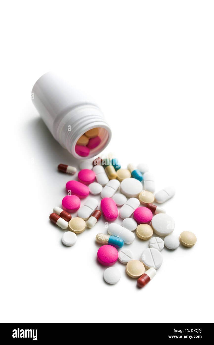 spilled colorful pills from medical bottle Stock Photo