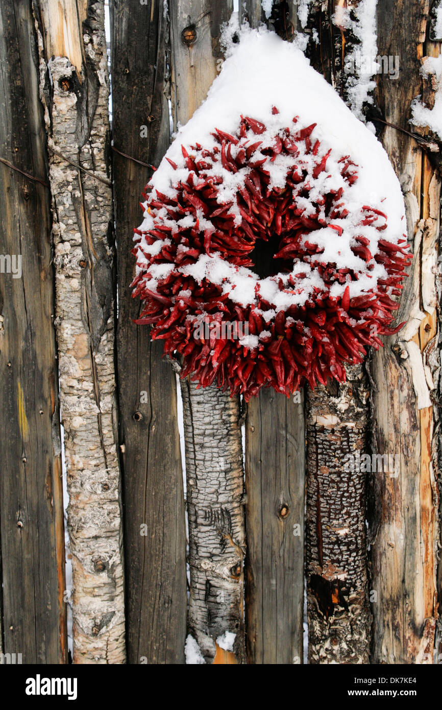 Santa Fe, New Mexico, United States. Chile ristra wreath on coyote fence. Stock Photo