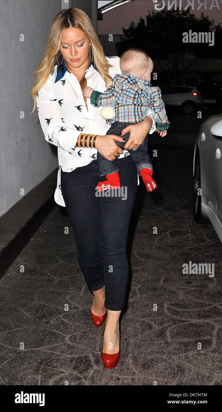 Hilary Duff carries her son Luca as she celebrates her birthday with a