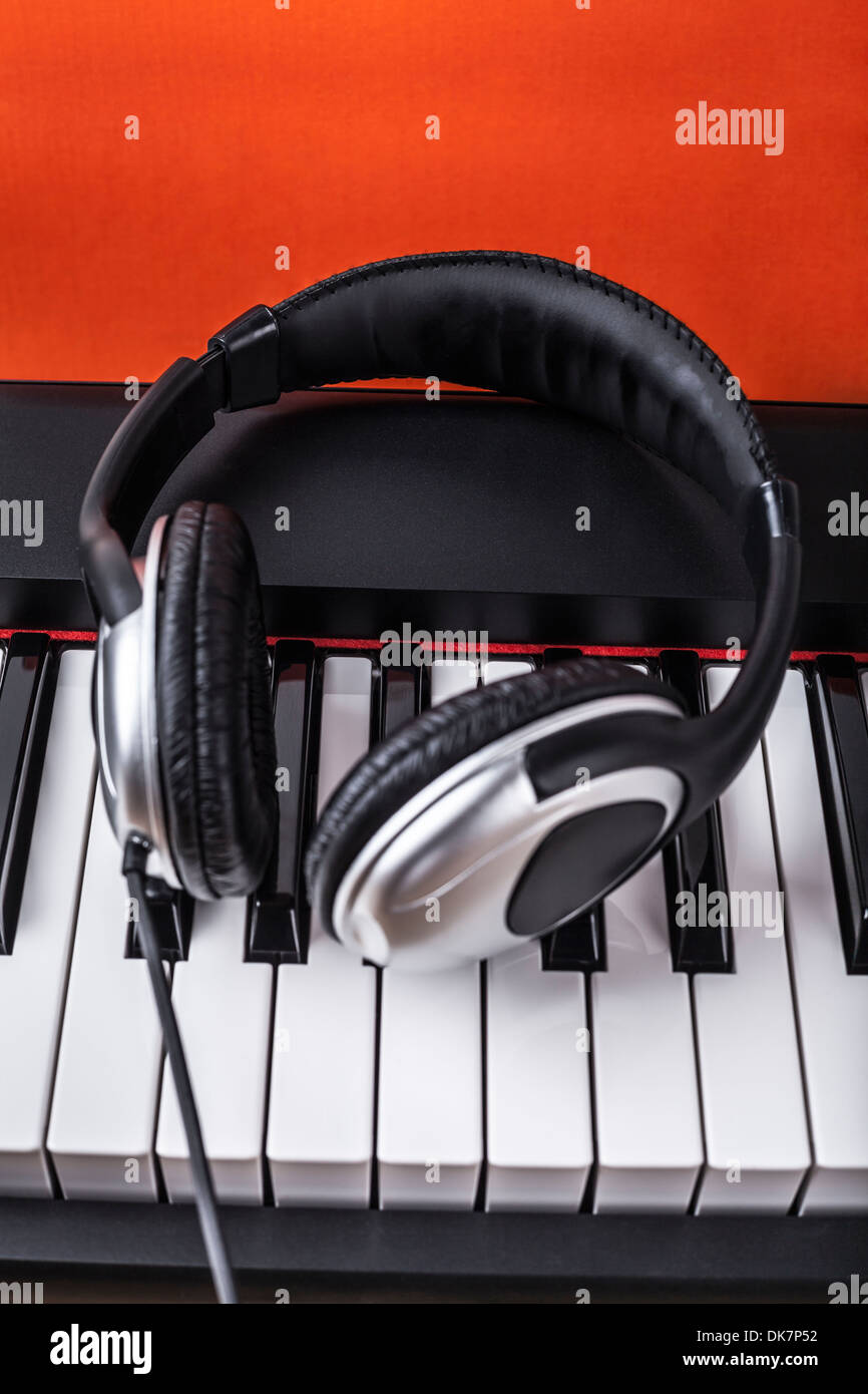 Detail of piano keyboard with headphones Stock Photo Alamy