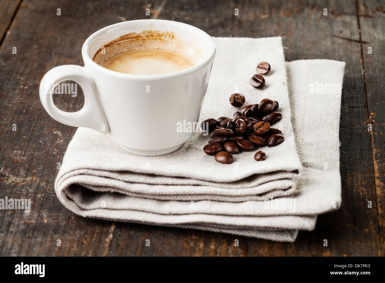 Coffee cup with coffee beans on wooden background Stock Photo