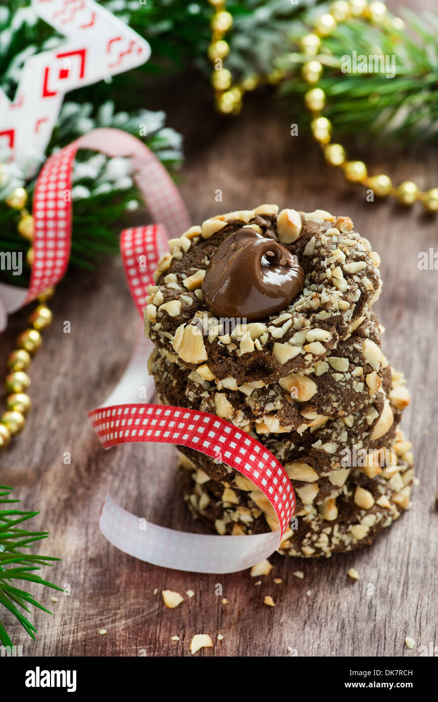 Chocolate filled cookies with hazelnuts, festive decorations, selective