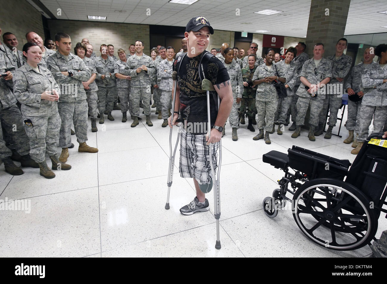 June 30, 2011 - Memphis, TN, U.S. - June 30, 2011 - Tennessee Air National Guard Staff Sergeant Russell Logan (middle) is greeted by several members of his 164th Airlift Wing Unit at the Memphis International Airport for his first trip home after losing the lower part of his left leg while stepping on a roadside bomb in Afghanistan on Motherâ€™s Day of  this year.  Logan who will r Stock Photo