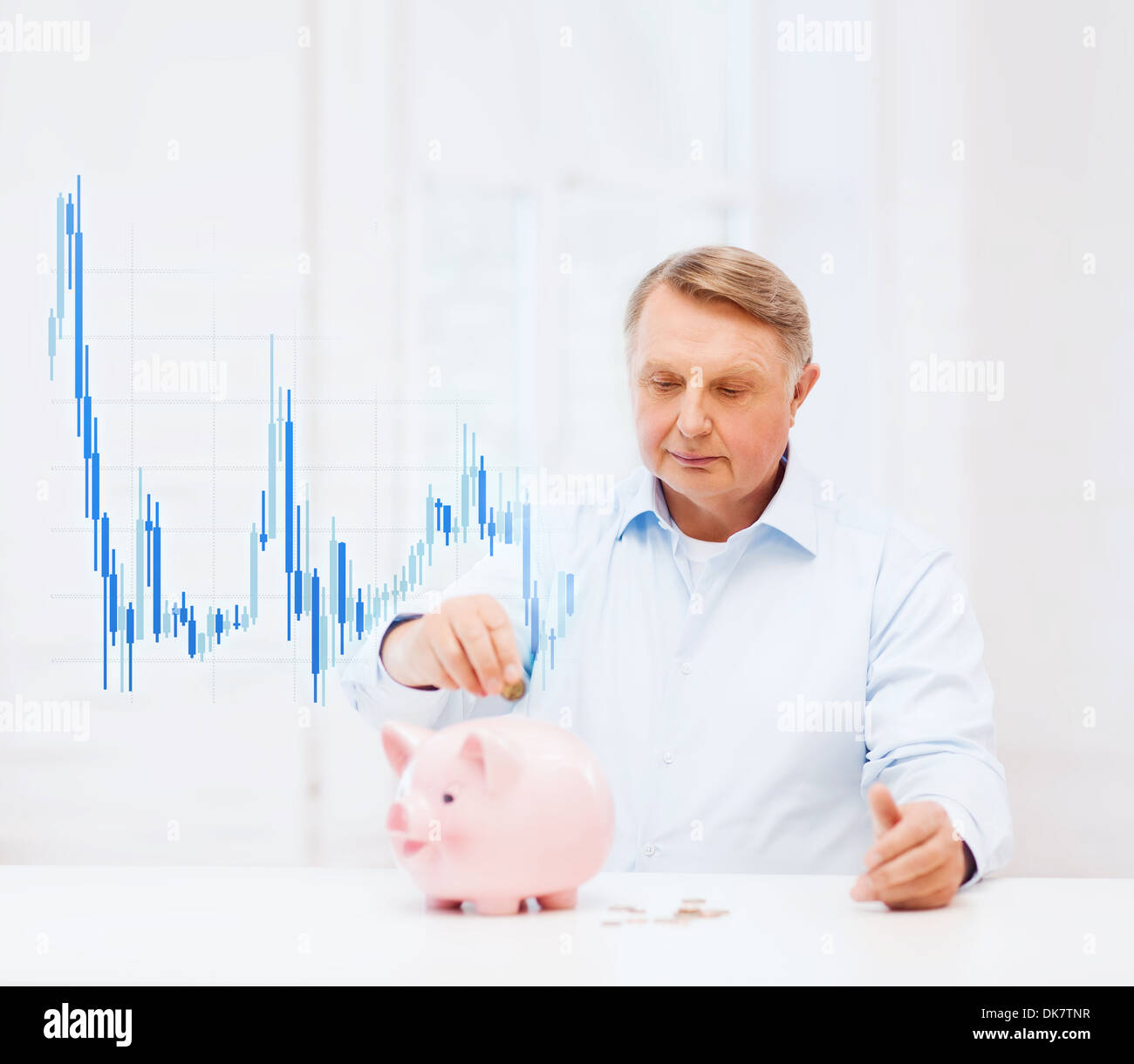 old man putting coin into big piggy bank Stock Photo - Alamy