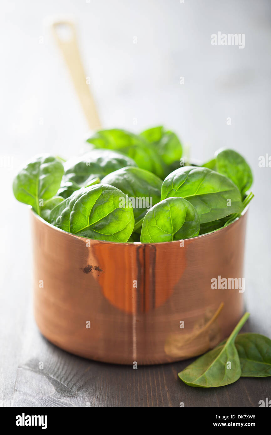 baby spinach leaves in copper pot Stock Photo