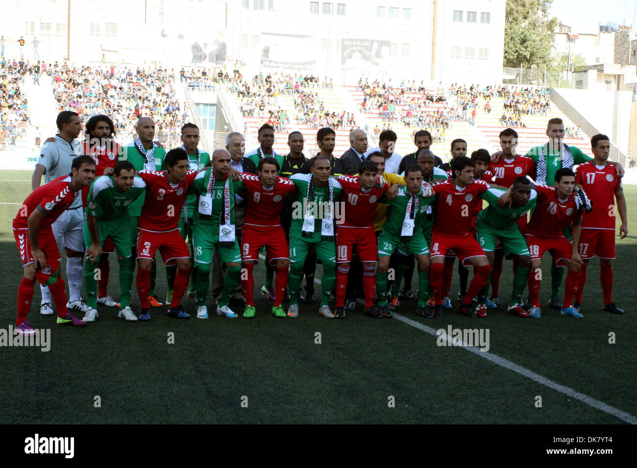 Jul 3, 2011 - Ramallah, West Bank - Palestinian players and Afghanistan players pose for pictures during a soccer match between the Palestinian and Afghanistan national teams in the West bank city of Ramallah, Sunday. The Palestinian national soccer team drew 1-1 against Afghanistan on Sunday, a score that advances the Palestinians to the next qualifying round for the World Cup set Stock Photo