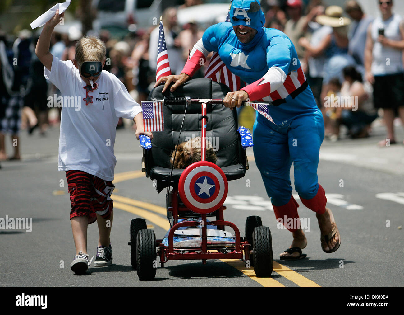 July 04, 2011 - San Clemente, California, U.S. - KEVIN WAGGONER pushes his 'office chair' up Avenida Rosa during the 6th annual Unofficial San Clemente Office Chair Races on Avenida Rosa.  Originally started with real office chairs, contest organizers now admit their definition of an office chair is ''loosely defined.''  The annual Fourth of July event attracts a couple of hundred  Stock Photo