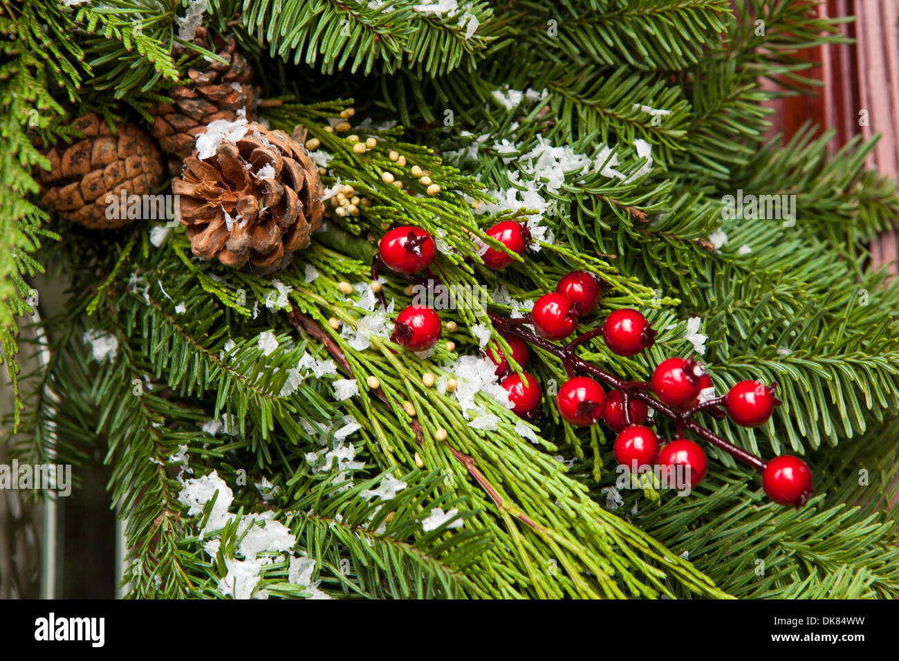 Green Holiday Christmas Decoration with Evergreen and Berries Stock Photo