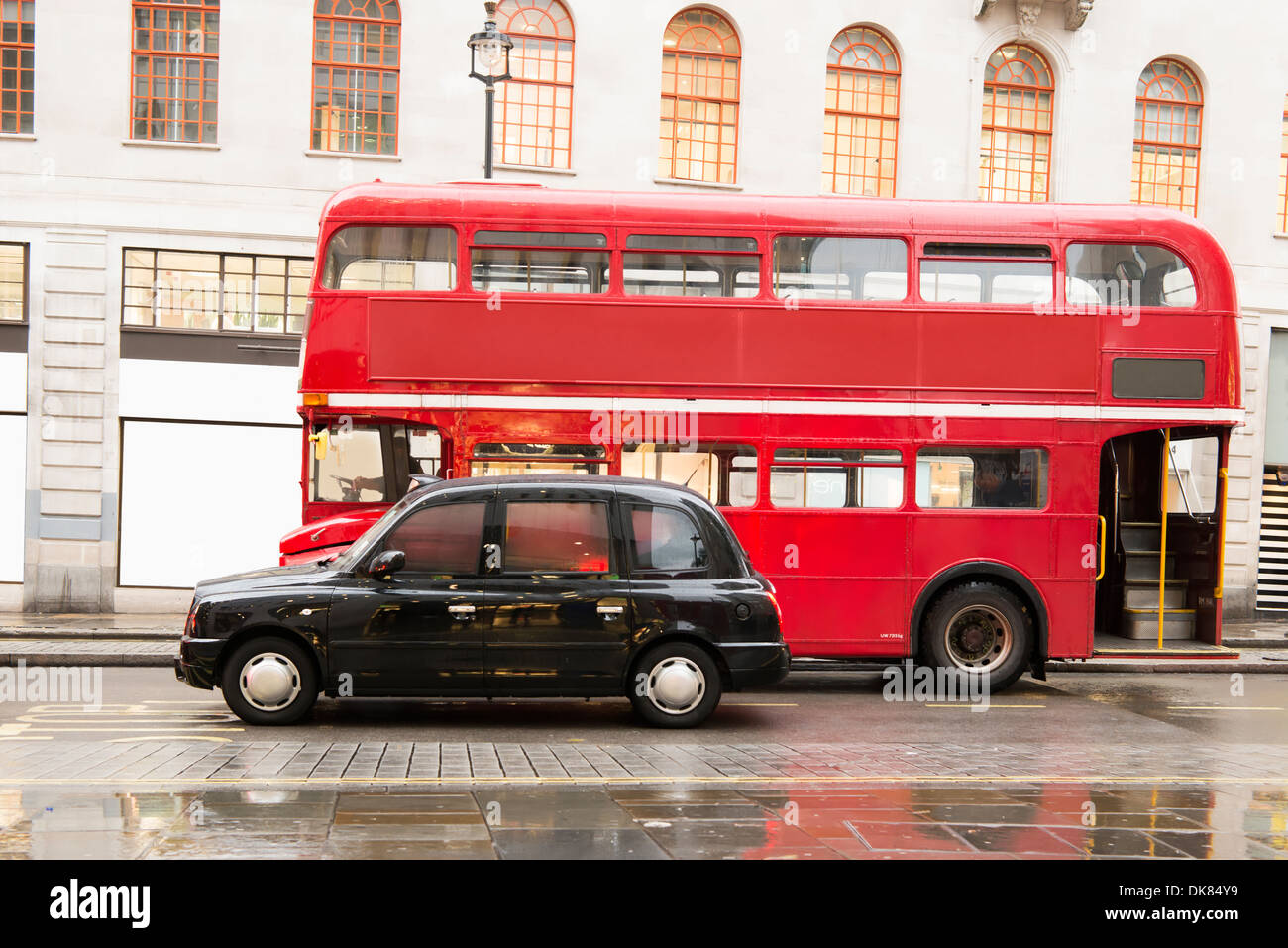 Red vintage bus and classic style taxi in London. London City tour Stock Photo