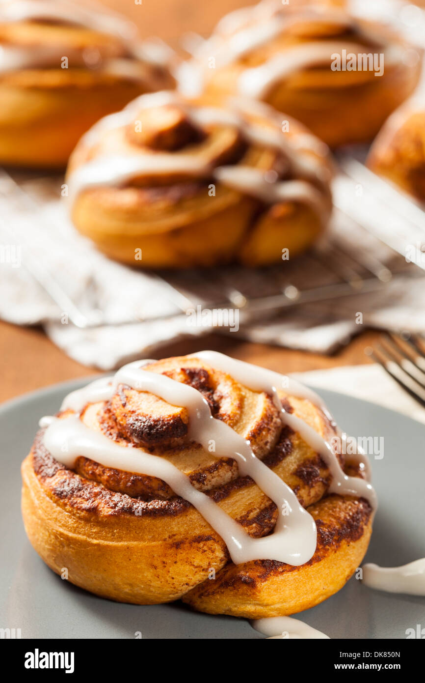 Homemade Cinnamon Roll Pastry with Vanilla Icing Stock Photo
