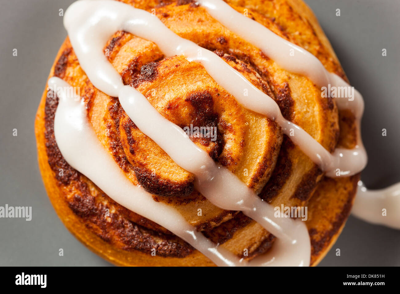 Homemade Cinnamon Roll Pastry with Vanilla Icing Stock Photo