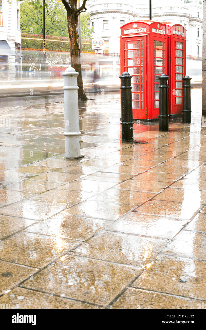 Red Phone cabines in London.Rainy day. Vintage phone cabine monumental Stock Photo
