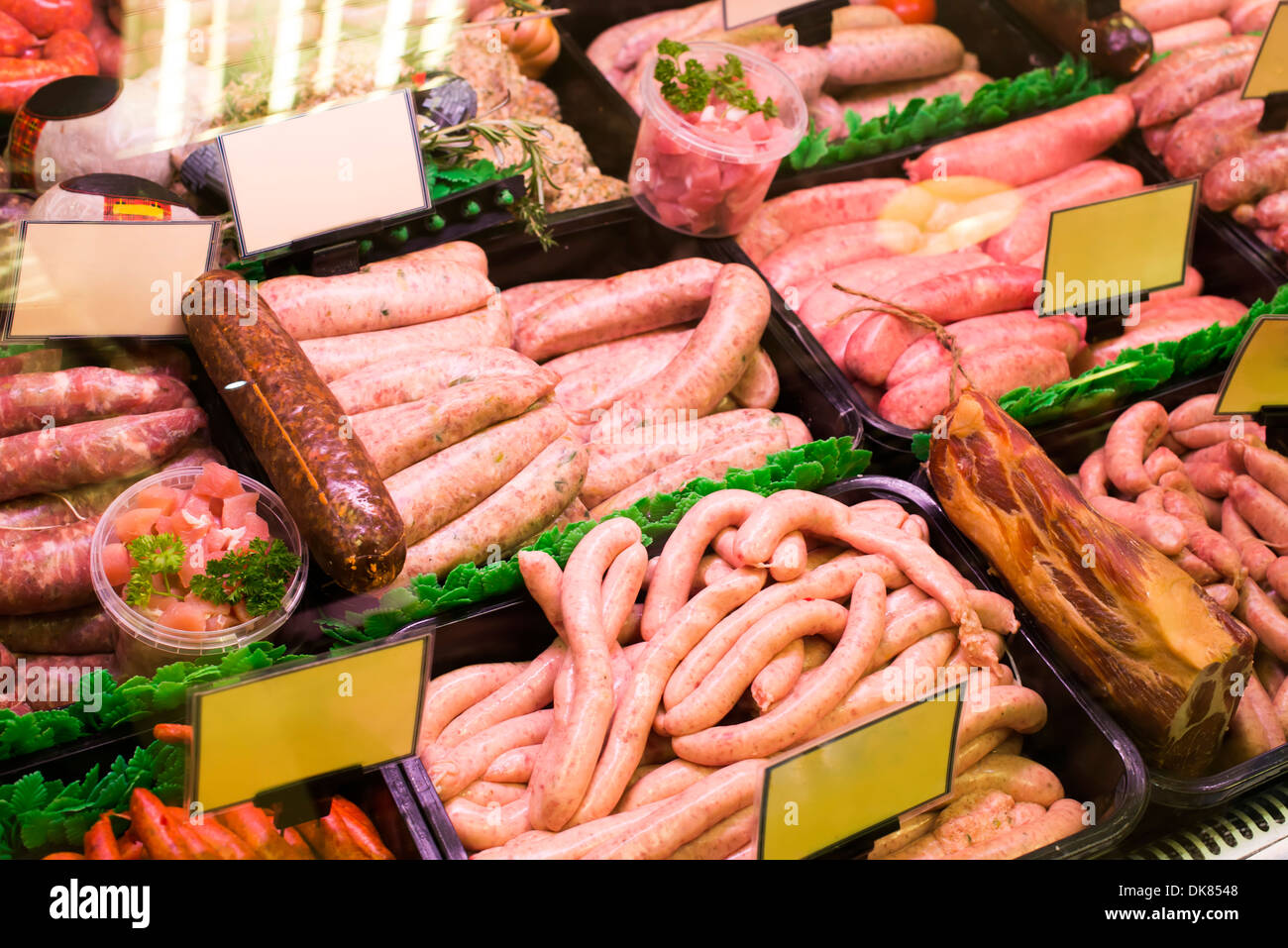 Meat and sausages in a butcher shop. Stand Stock Photo