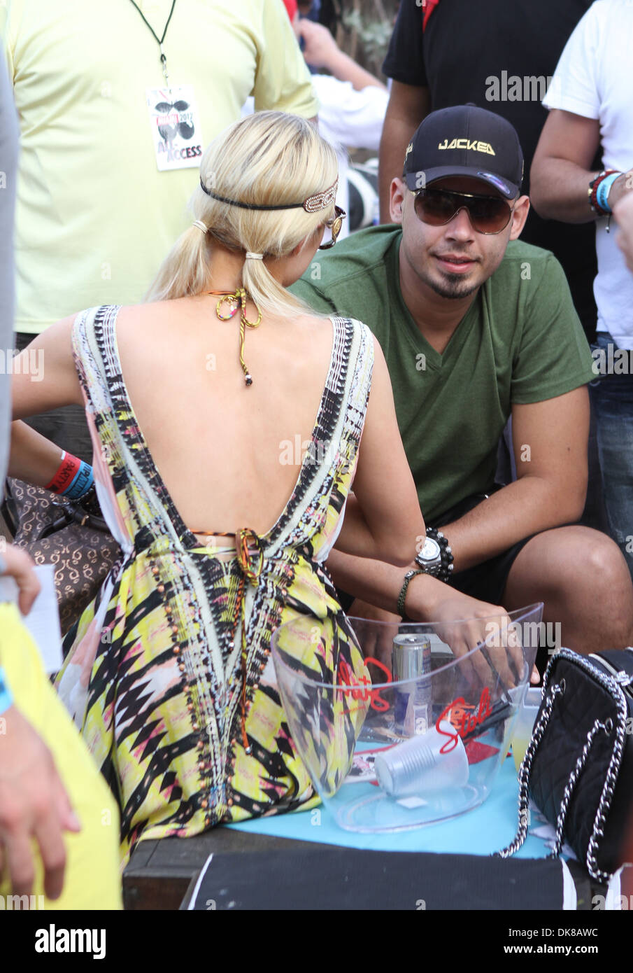 Paris Hilton wearing a colorful bikini top attends her boyfriend DJ