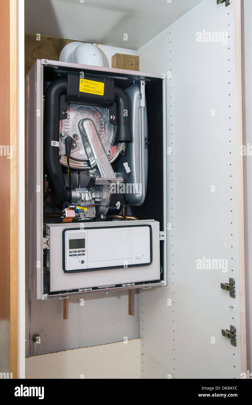 New installation of a Vaillant ecoTEC pro 28 combination boiler in kitchen cupboard Stock Photo