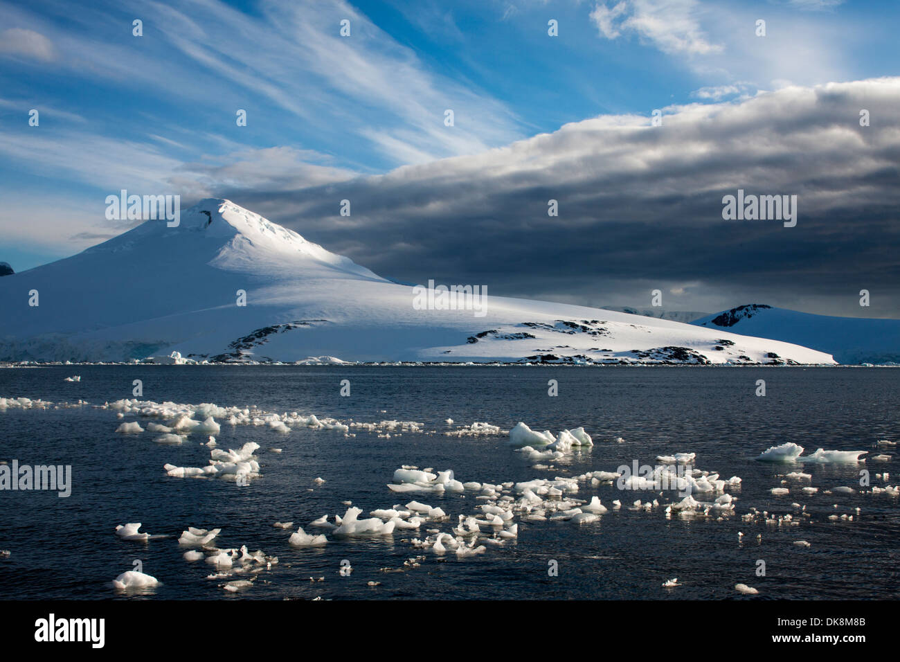Antarctica, Wiencke Island, Setting sun lights mountain peaks along Neumayer Channel Stock Photo