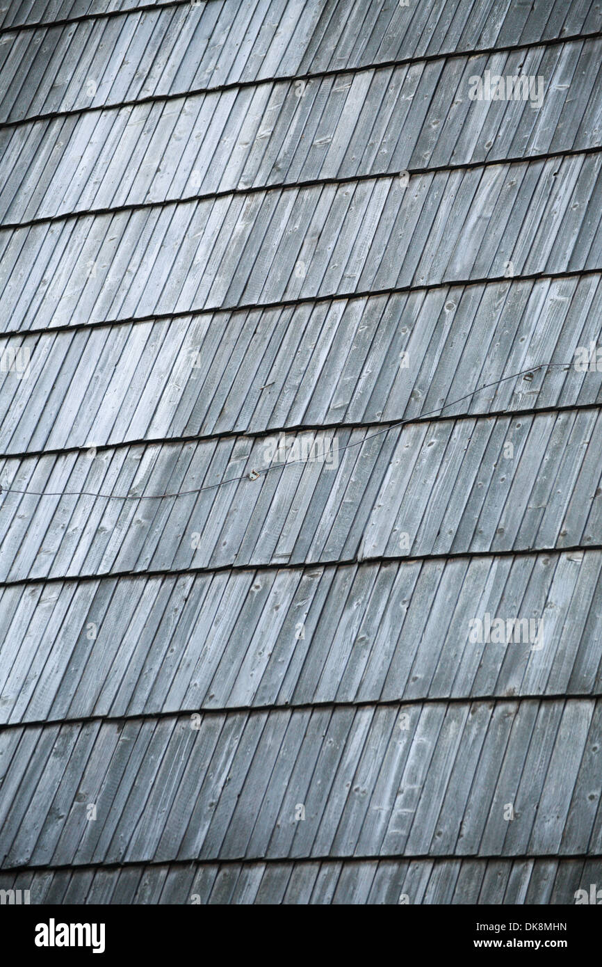 Detail of protective wooden shingle on the old roof as background Stock Photo