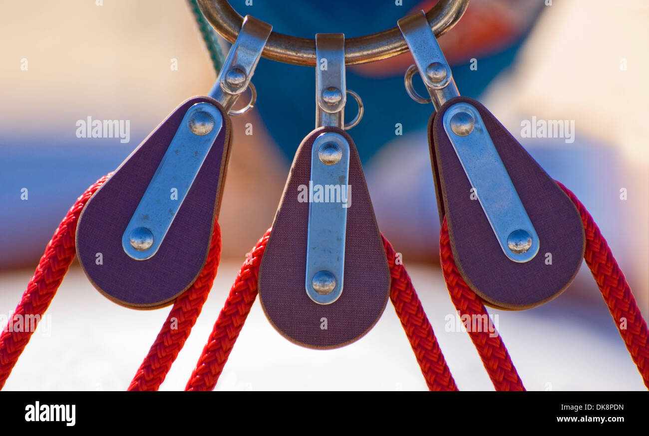 Three sailing pulleys with a red rope on the boom Stock Photo