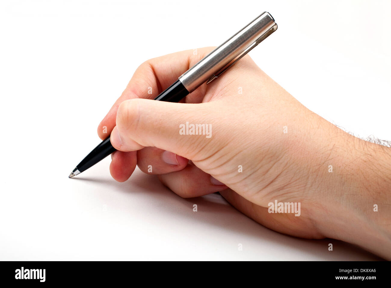 Hand holding a pen in the writing position. Stock Photo