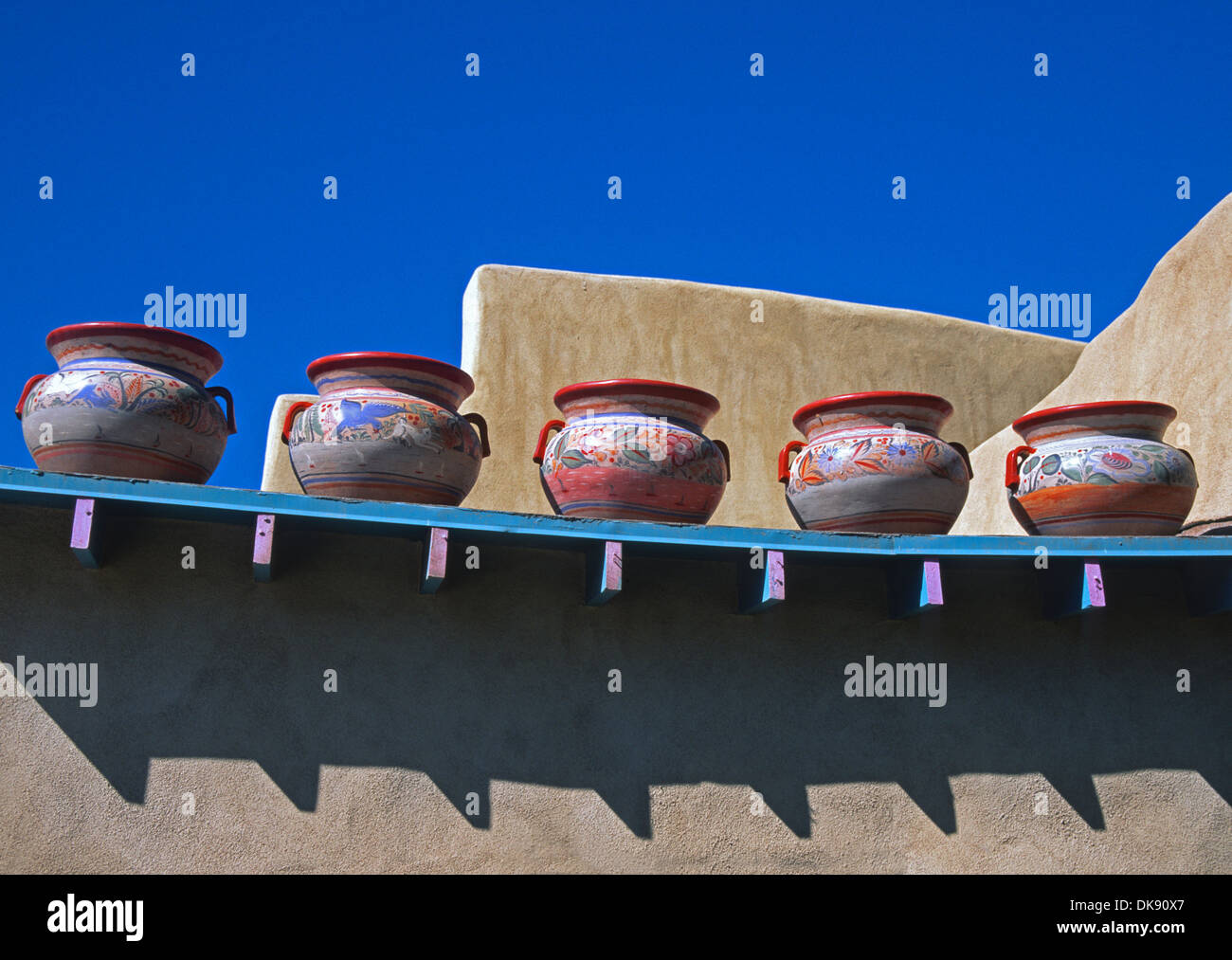 Decorative pottery jars displayed on wall in Taos, New Mexico. Stock Photo
