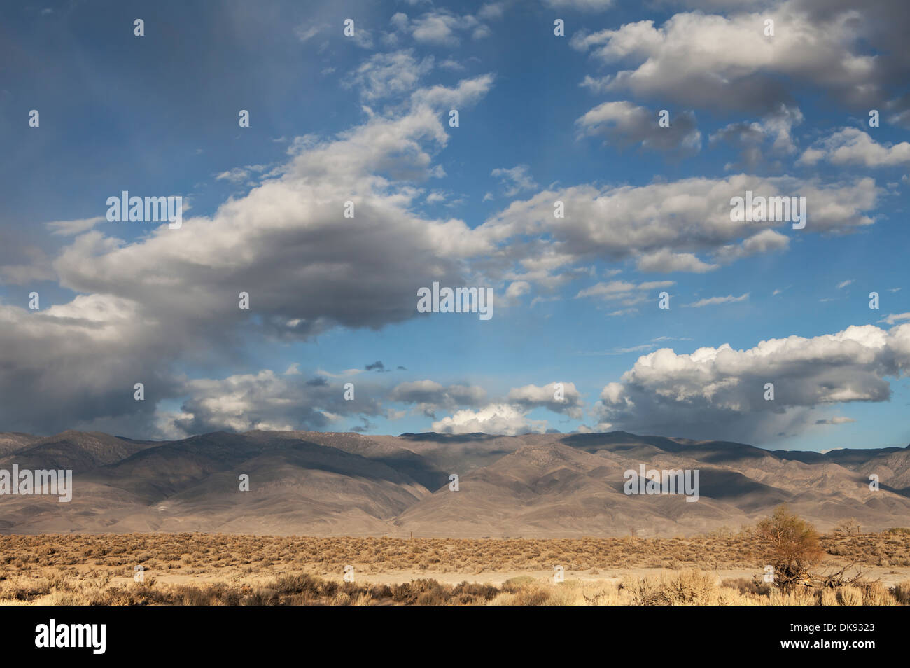 Interesting clouds forming shadows on mountains in the California high desert. Stock Photo