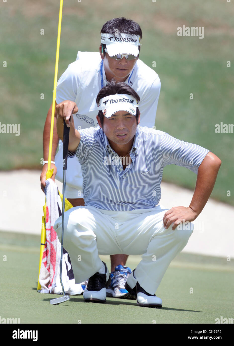 Aug. 14, 2011 - Johns Creek, GEORGIA, U.S. - Golfer Yuta Ikeda (BOTTOM) of Japan and his caddie Hisashi Fukuda line up his putt on the 14th green during the 4th and final round of 93rd PGA Championship at the Atlanta Athletic Club in Johns Creek, Georgia, USA on 14 August 2011. (Credit Image: © Erik Lesser/ZUMAPRESS.com) Stock Photo