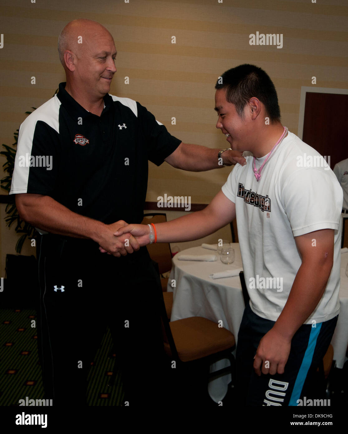 Aug. 17, 2011 - Aberdeen, Maryland, U.S. - Hall of Fame Baseball Player Cal Ripken, Jr. greets high school athletes from earthquake affected areas of Japan who are in the U.S. as part of the Sports United Visitors Program.  Ripken was designated a Special Public Diplomacy Envoy  to the U.S. State Department. Today's visit was part of his mission to use baseball as a tool to spread  Stock Photo