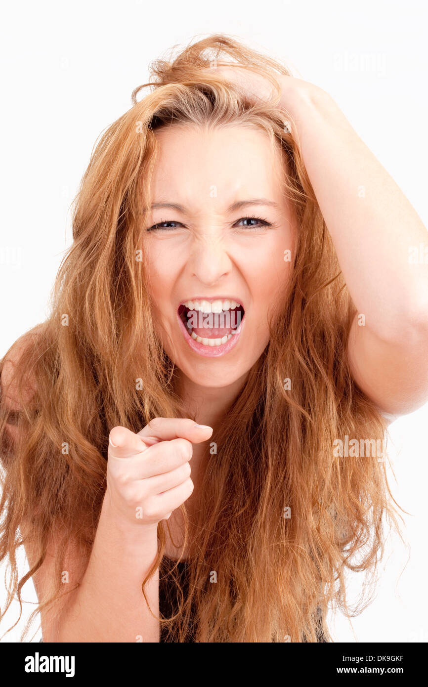 Frustrated Girl with Long Brown Hair Screaming, Pointing with Index Finger Stock Photo