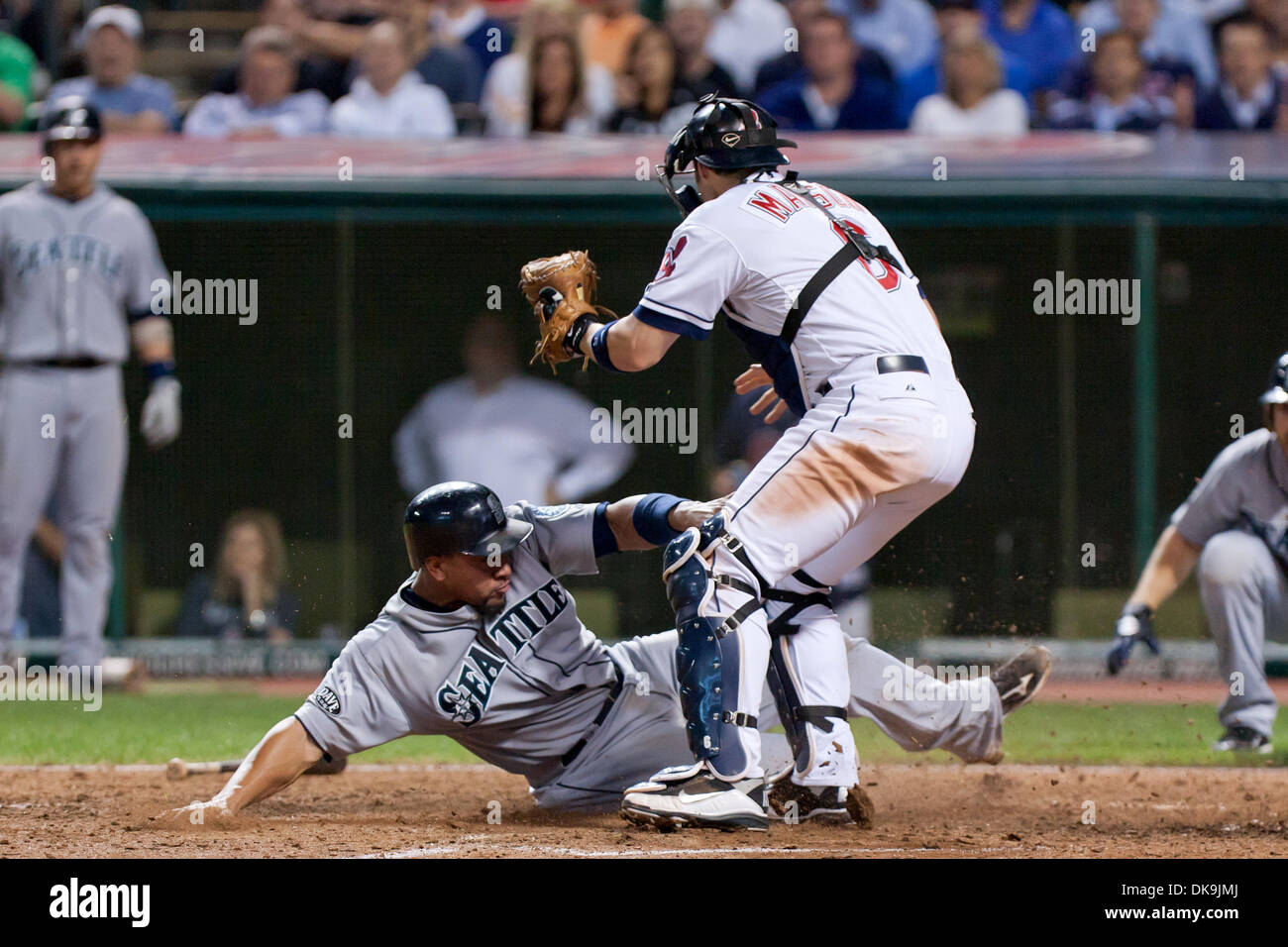 Aug. 22, 2011 - Cleveland, Ohio, U.S - Seattle catcher Miguel Olivo (30) slides safely into home ahead of the tag by Cleveland catcher Lou Marson (6) during the ninth inning.  The Seattle Mariners defeated the Cleveland Indians 3-2 at Progressive Field in Cleveland, Ohio. (Credit Image: © Frank Jansky/Southcreek Global/ZUMAPRESS.com) Stock Photo