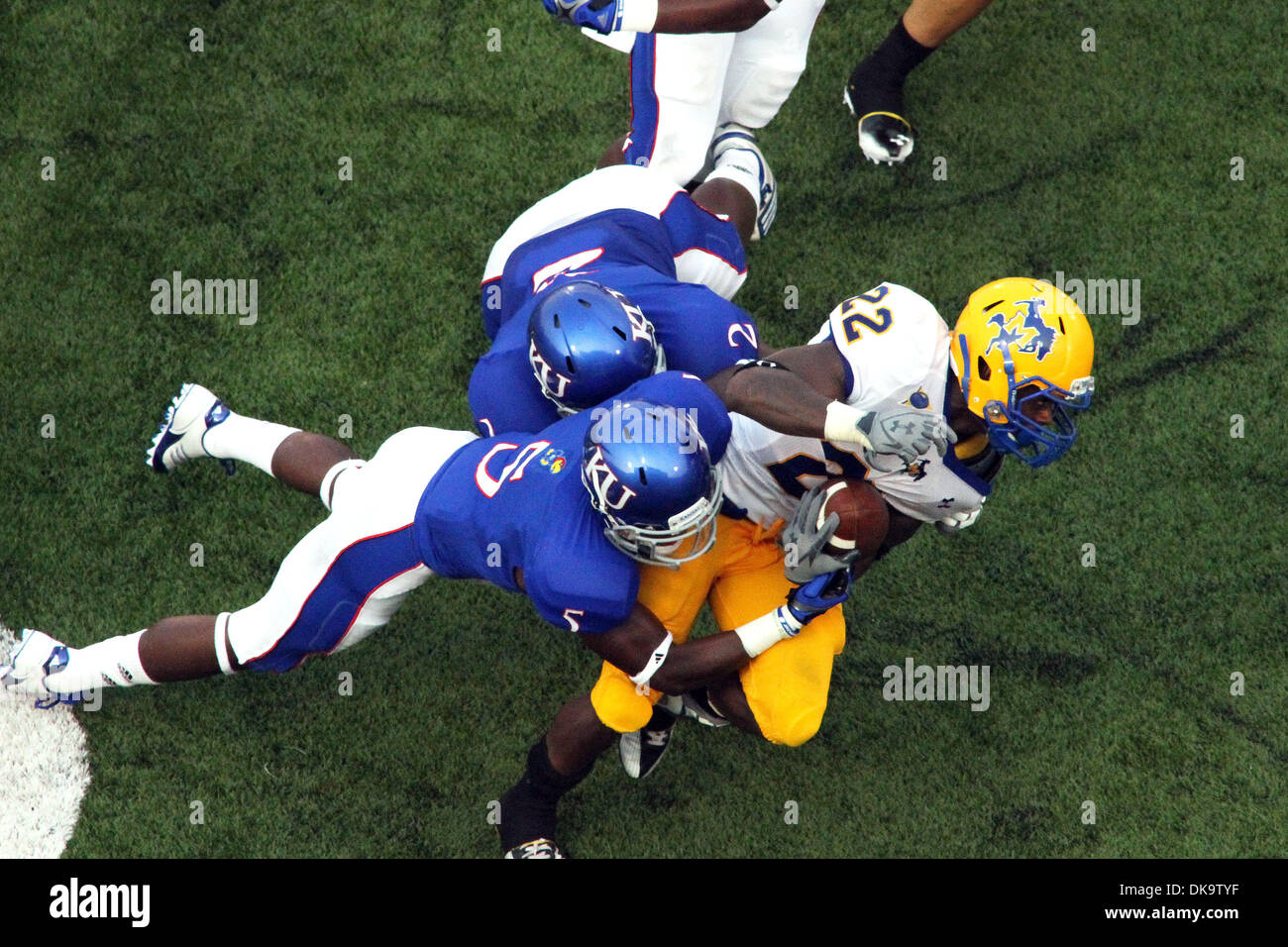 Sept. 3, 2011 - Lawrence, Kansas, United States of America - Mcneese State Cowboys running back Andre Anderson (22) is brought down by Kansas Jayhawks cornerback Greg Brown (5) and linebacker Darius Willis (2) during first half action. Kansas leads McNeese State 21-3 at halftime in the game at Memorial Stadium in Lawrence, Kansas. (Credit Image: © Jacob Paulsen/Southcreek Global/ZU Stock Photo