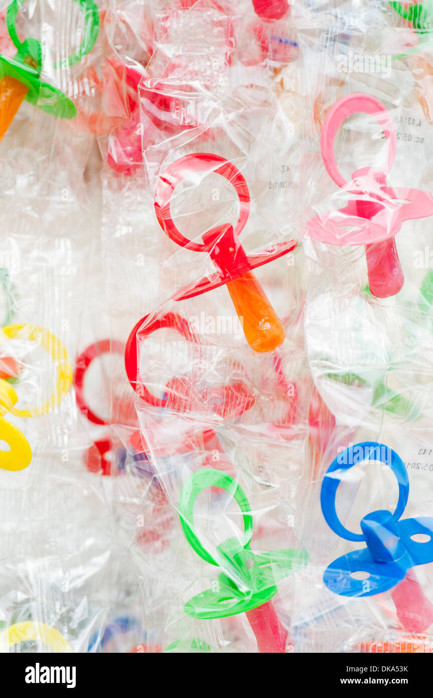 Packaged baby soothers for sale in a market in Catania, Sicily, Italy Stock Photo
