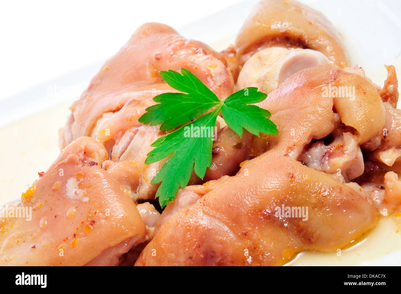 closeup of a plate with manitas de cerdo, spanish stewed pigs trotters Stock Photo