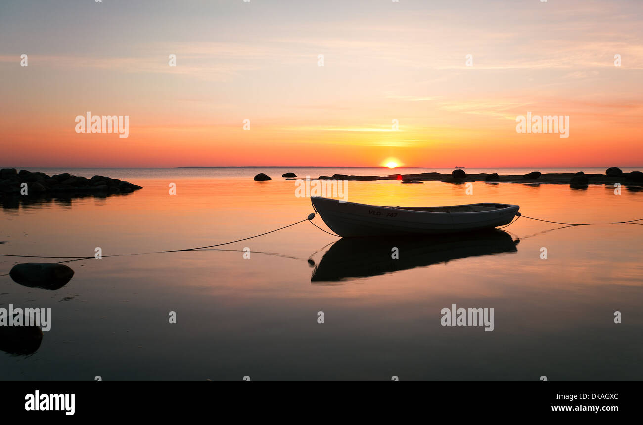 Silhouette of a boat in water at sunset Stock Photo - Alamy