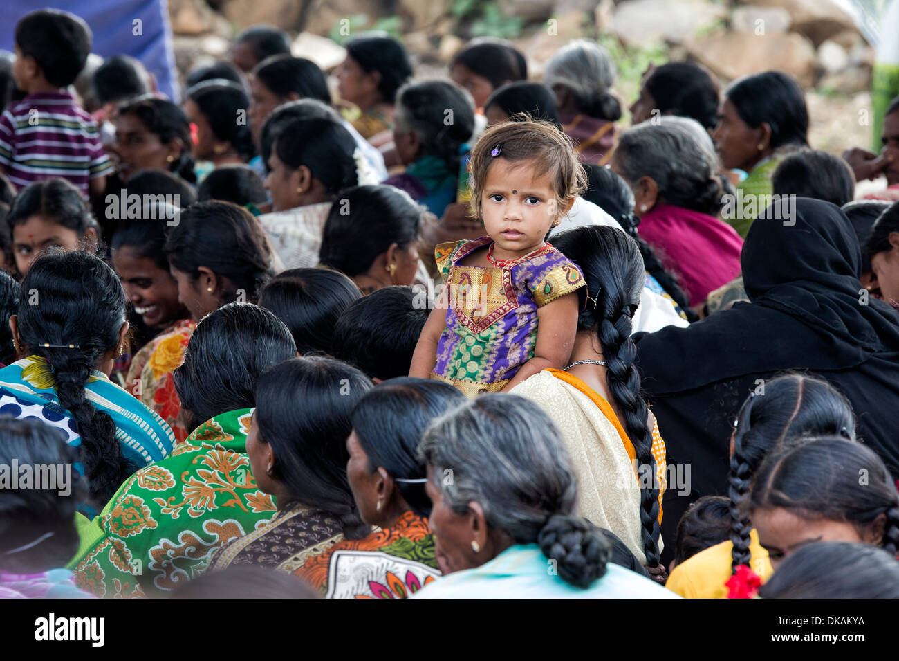 Young Indian girl with her mother in a crowd. Andhra Pradesh, India Stock Photo