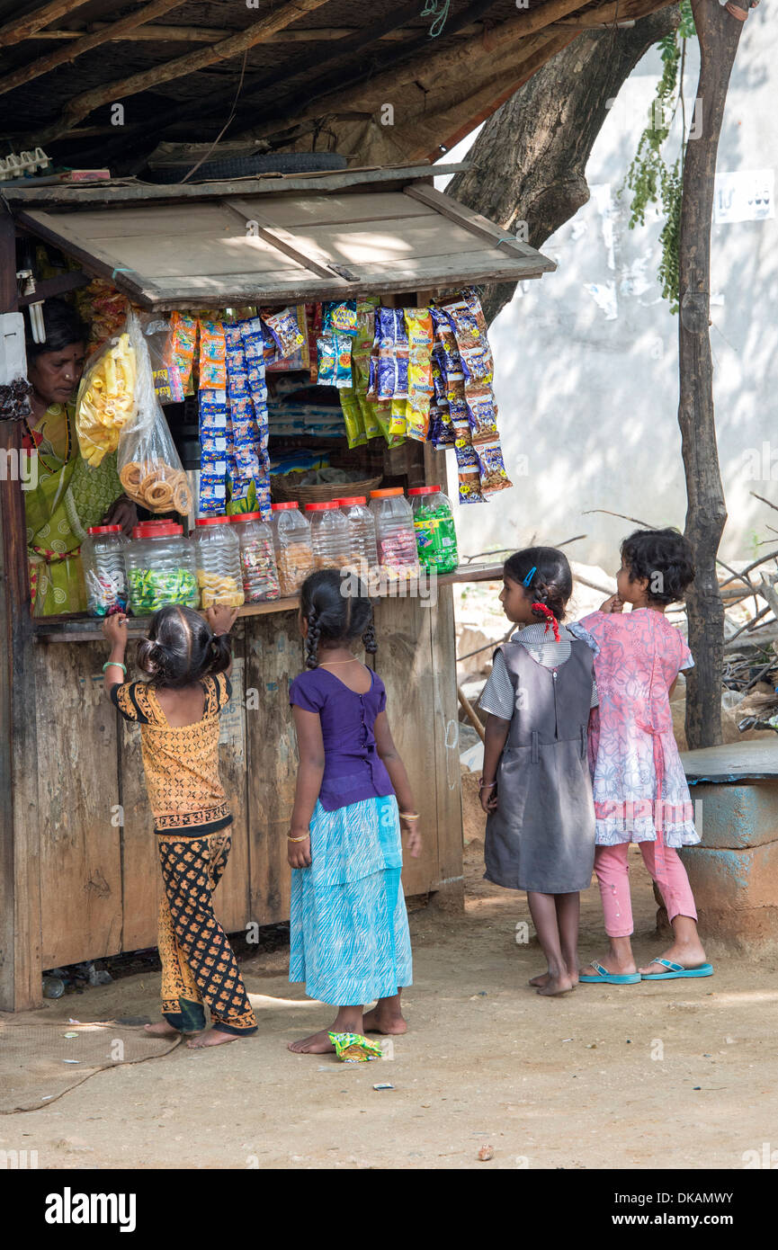 Indian children buying sweet from a rural village shop. Andhra Pradesh, India Stock Photo